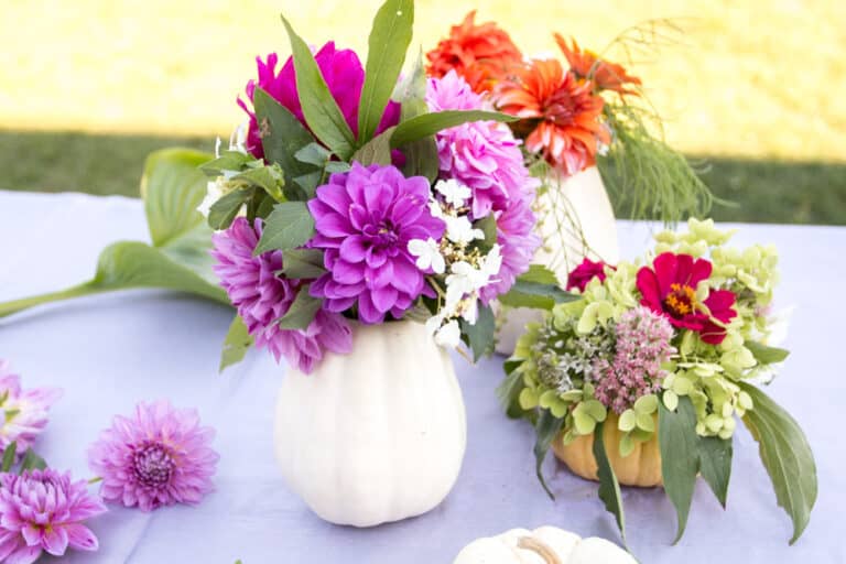 diy pumpkin vases with colorful flowers inside