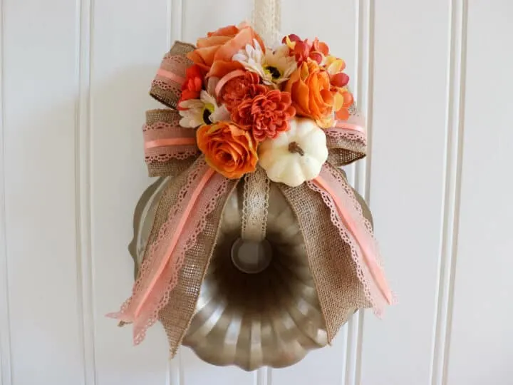 pumpkin wreath with flowers made out of a bundt pan