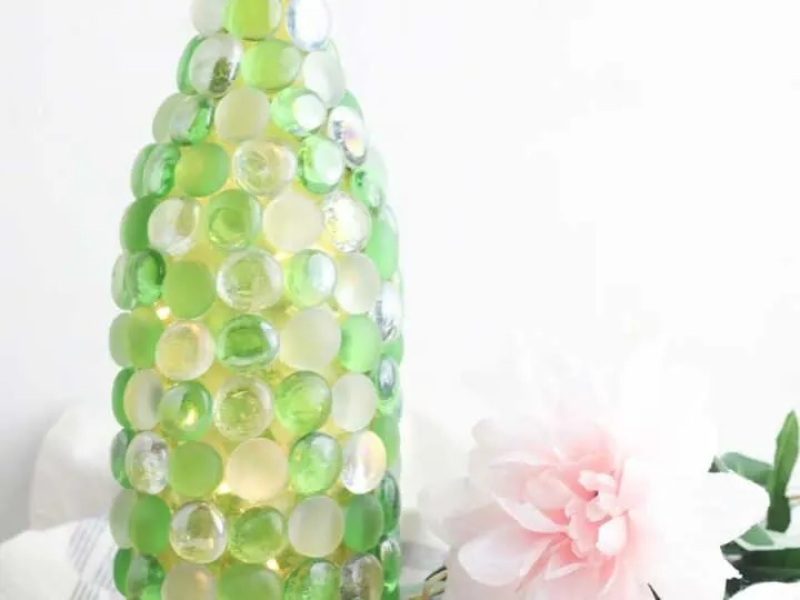 beaded glass bottle used as a vase