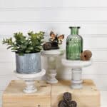 3 wooden pedestals with plants on top