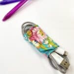 handmade sewn blue floral fabric cord wrapper around phone charging cord