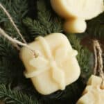 Christmas present beeswax ornament hanging on pine needles