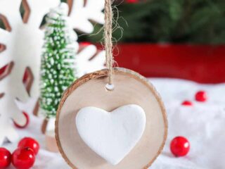 wood round ornament with white clay heart glued in center