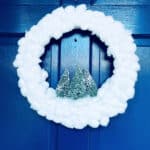 white cotton ball wreath on blue front door