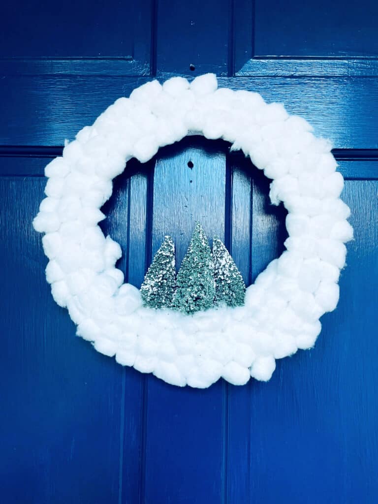 white cotton ball wreath on blue front door