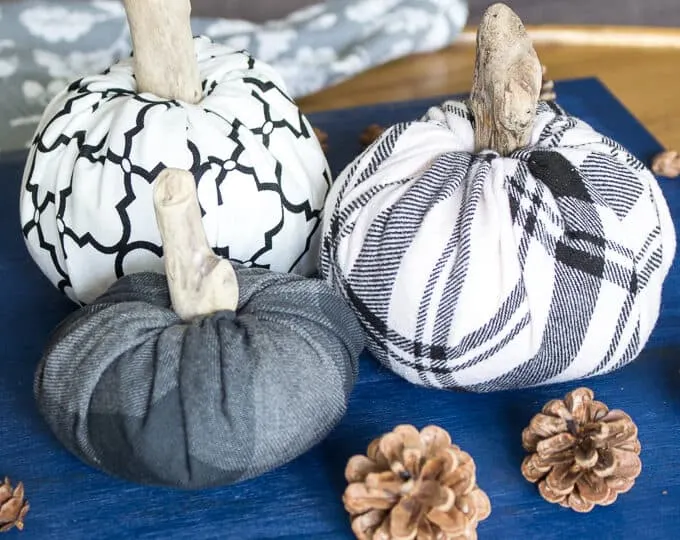 three no-sew fabric pumpkins made from white and grey flannel