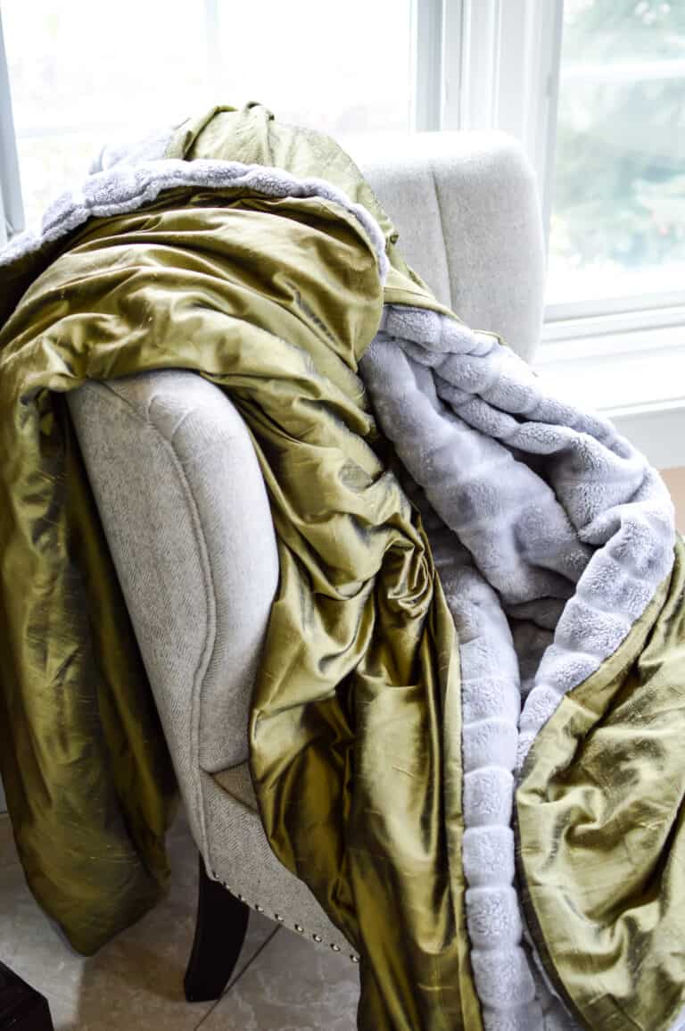handmade double sided blanket laying on upholstered chair