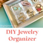 handmade jewelry tray organizer filled with accessories next to pink flowers on blue dresser
