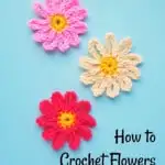 crochet flower petals with yellow centers on blue background