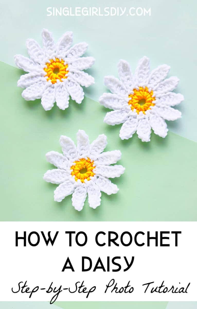 pretty crocheted daisy flowers on green background