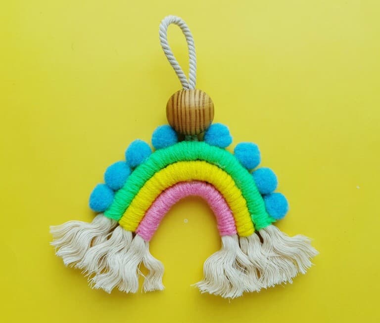 macrame rainbow on yellow wall