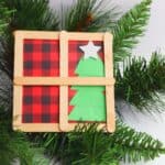 handmade miniature Christmas window made out of craft sticks and paper