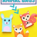 three cute paper animal bags on yellow background