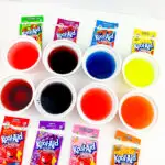 kool aid pouches next to cups of dyes