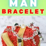 DIY snow person bracelet hanging on a small red gift box