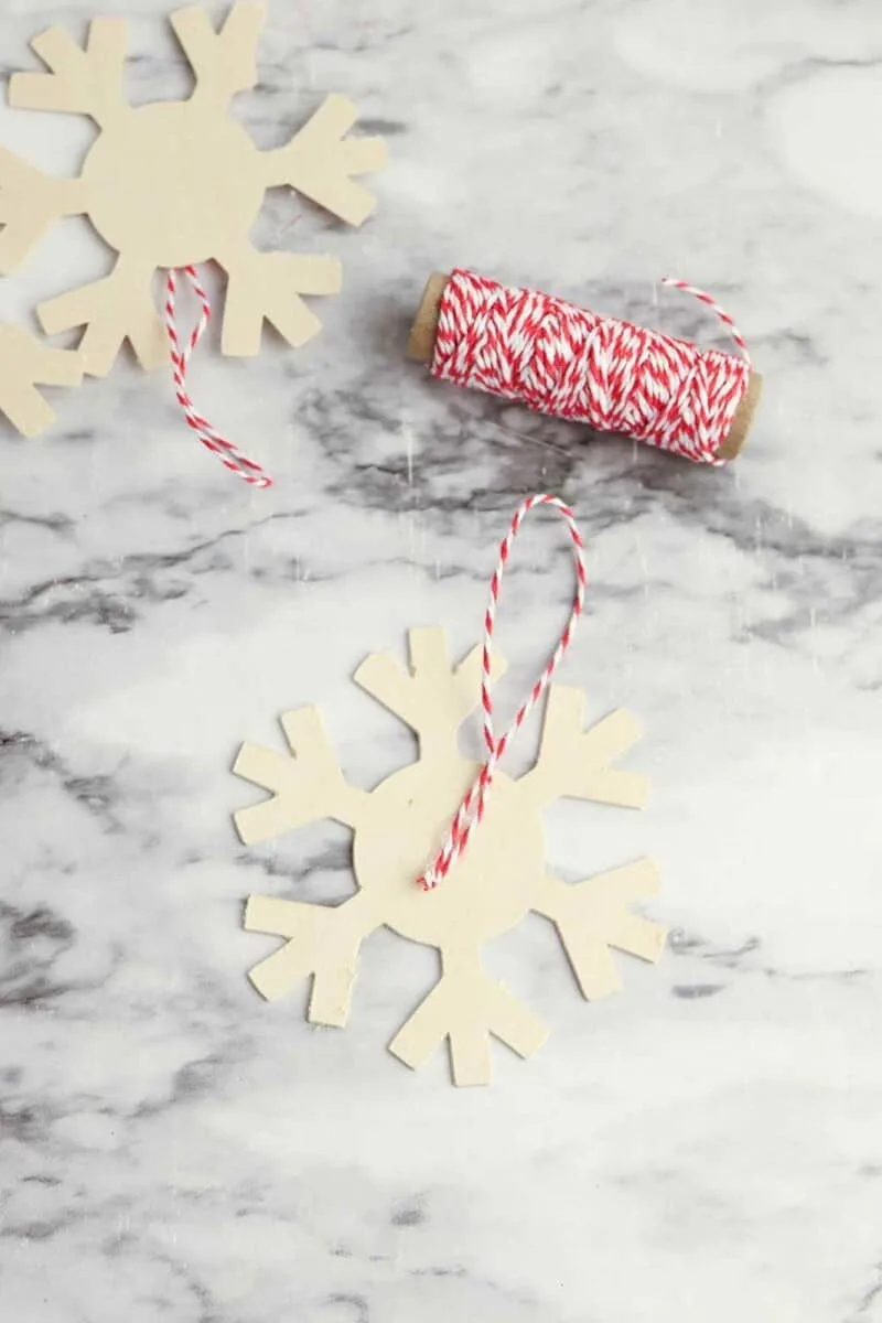 balsam wood snowflake cutout with red and white striped ribbon