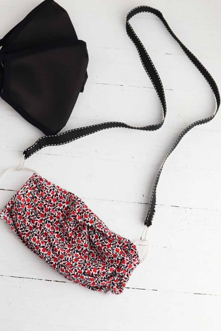 flower and black face masks on black lanyard