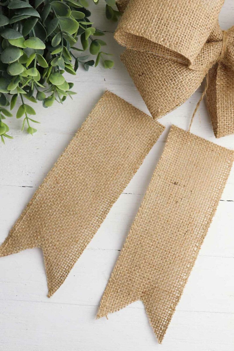 two six-inch pieces of burlap ribbon with trimmed ends forming two points at the bottom