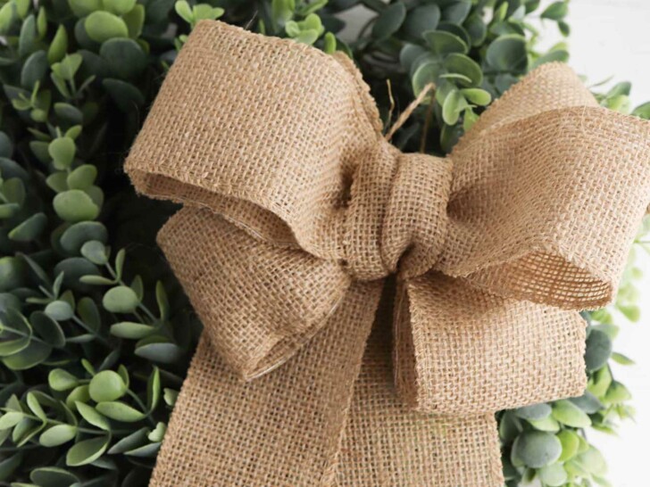 green wreath with a burlap bow