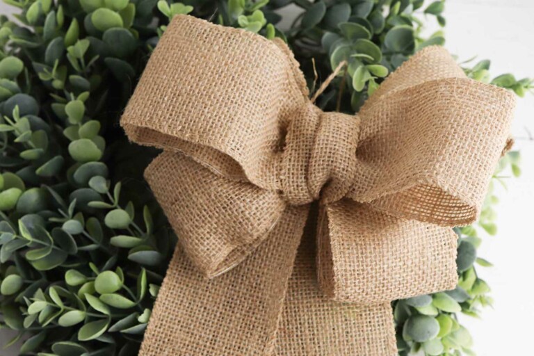 green wreath with a burlap bow