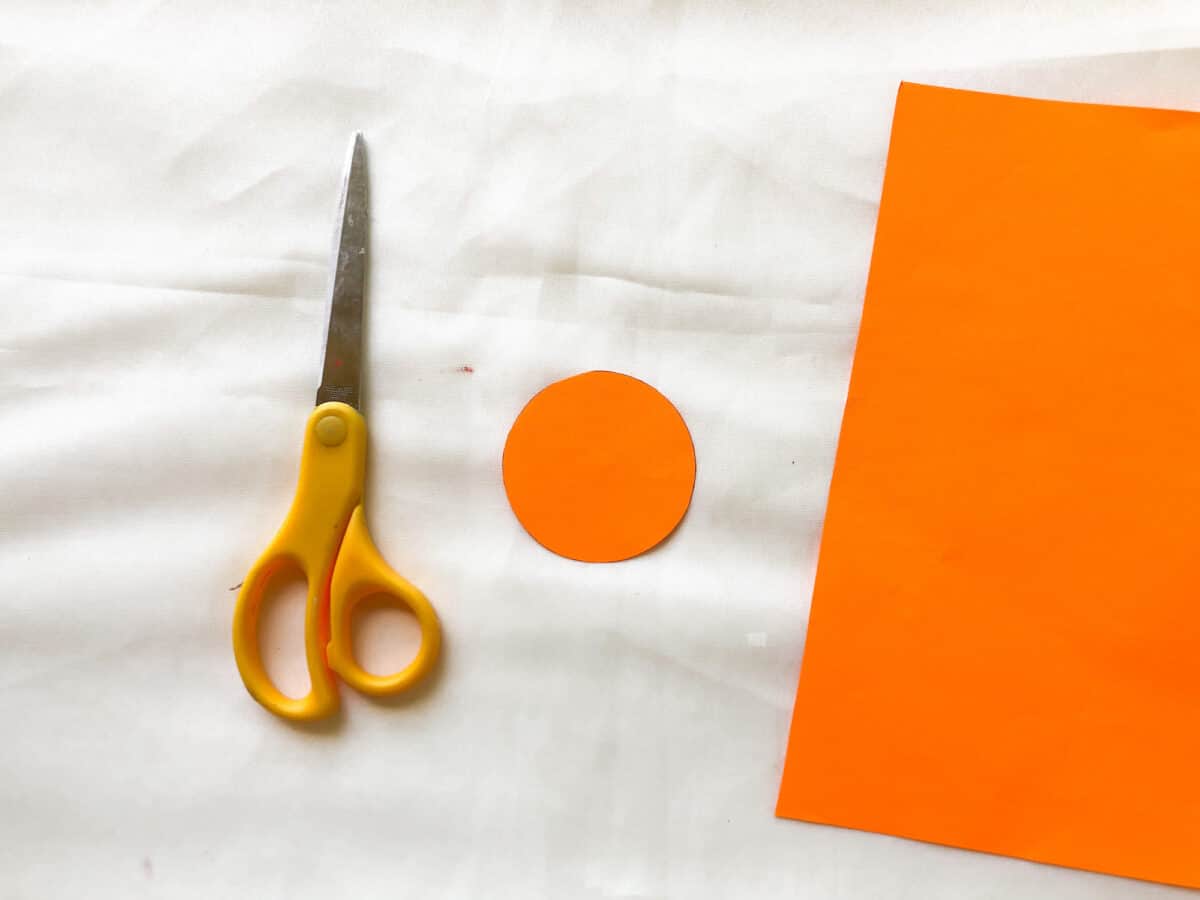 https://singlegirlsdiy.com/wp-content/uploads/2022/10/cutting-a-paper-circle-out-of-orange-construction-paper-1200x900.jpeg