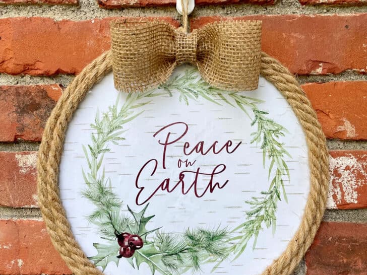 diy peace on earth wreath hanging on brick wall