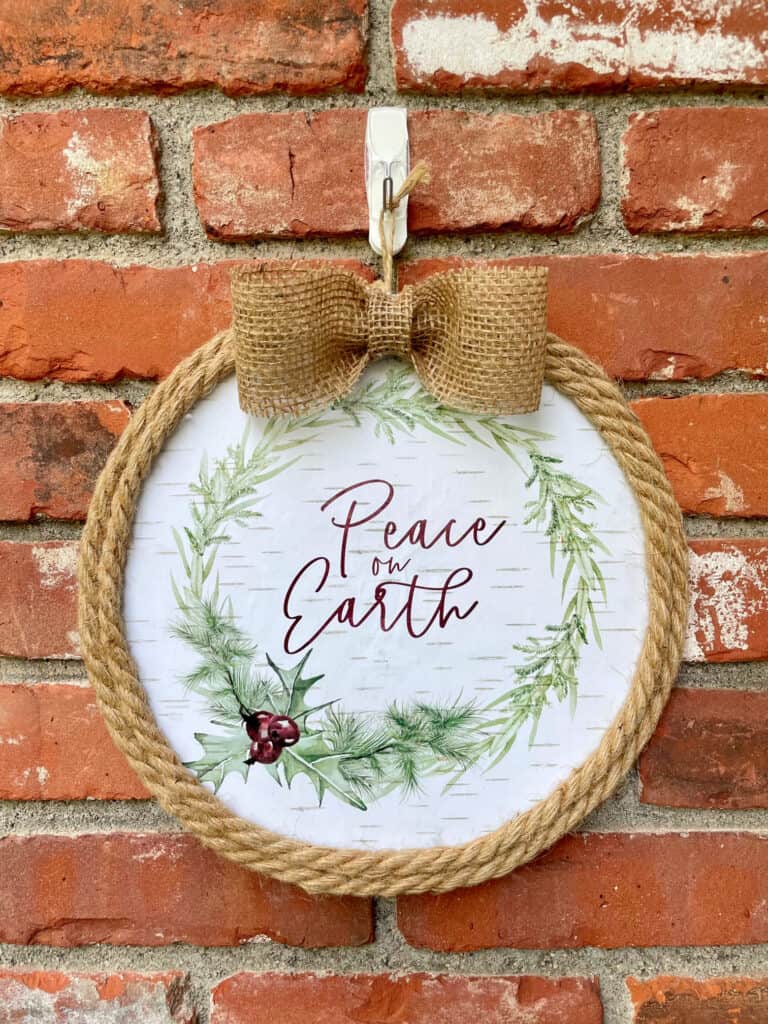 diy peace on earth wreath hanging on brick wall