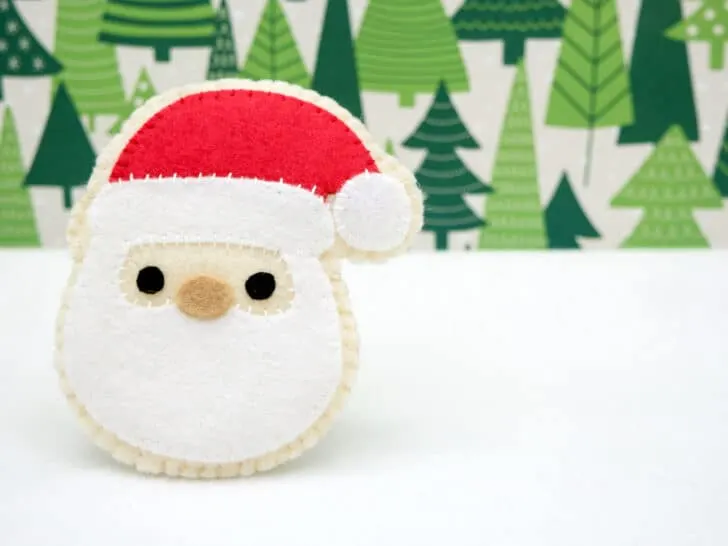 finished Santa cookie ornament with Christmas tree background