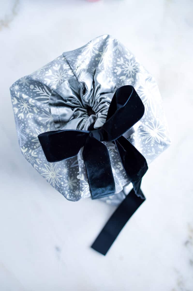 snowflake fabric gift bag with navy ribbon