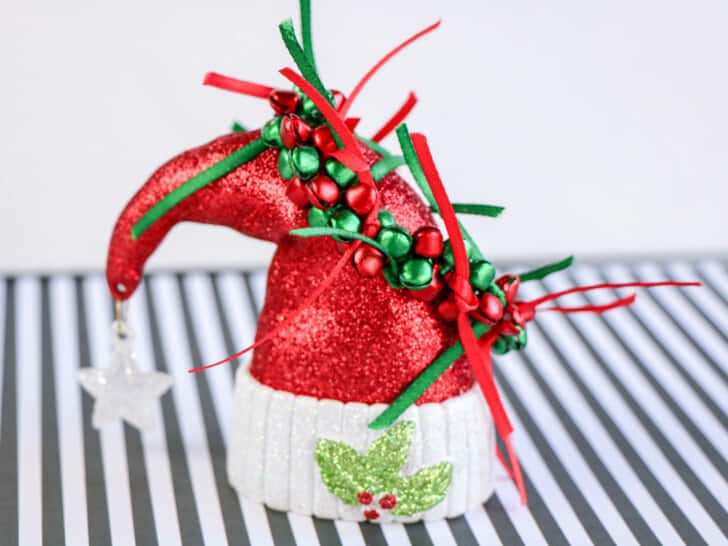 handmade jingle bells bracelet displayed on a Santa hat ornament