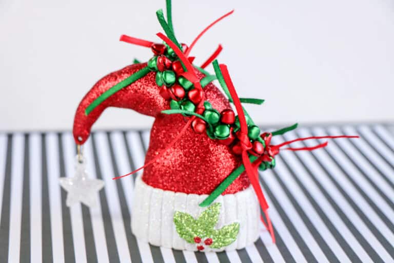 handmade jingle bells bracelet displayed on a Santa hat ornament