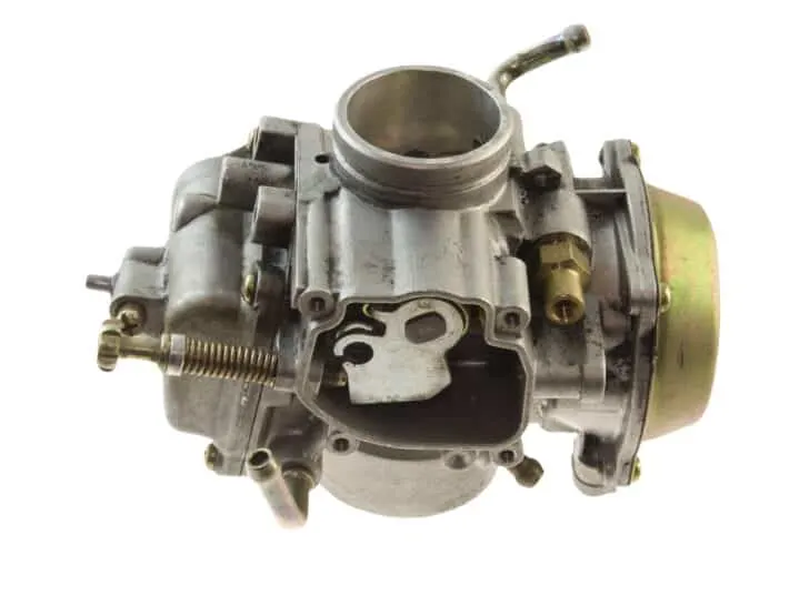 isolated carburetor from a small engine on white
