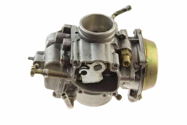 isolated carburetor from a small engine on white