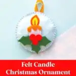 handmade Christmas candle ornament on blue background