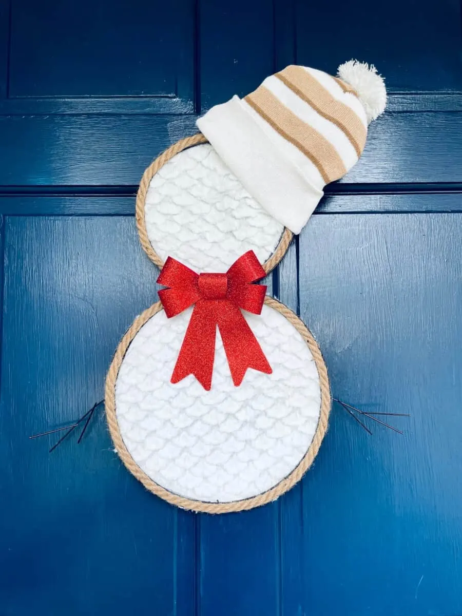 dollar tree snowman wreath with hat hanging on front door