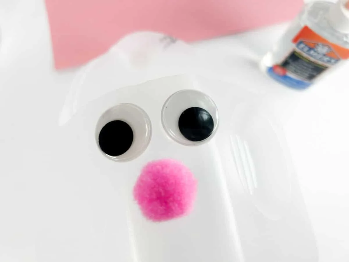 https://singlegirlsdiy.com/wp-content/uploads/2023/03/gluing-eyes-and-bunny-nose-on-diy-Easter-basket-from-a-milk-jug-1200x900.jpg.webp