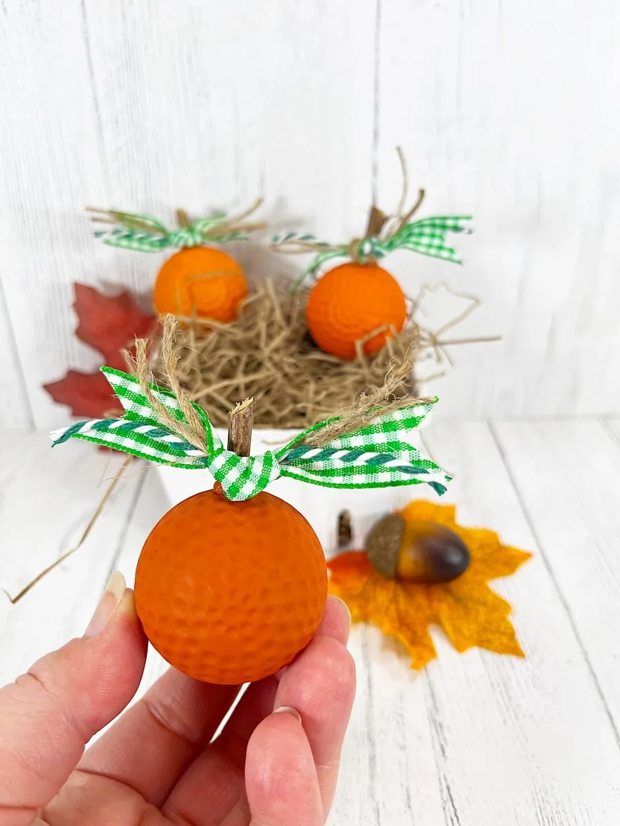 Golf Ball Pumpkins with green checkered ribbon Against White Background
