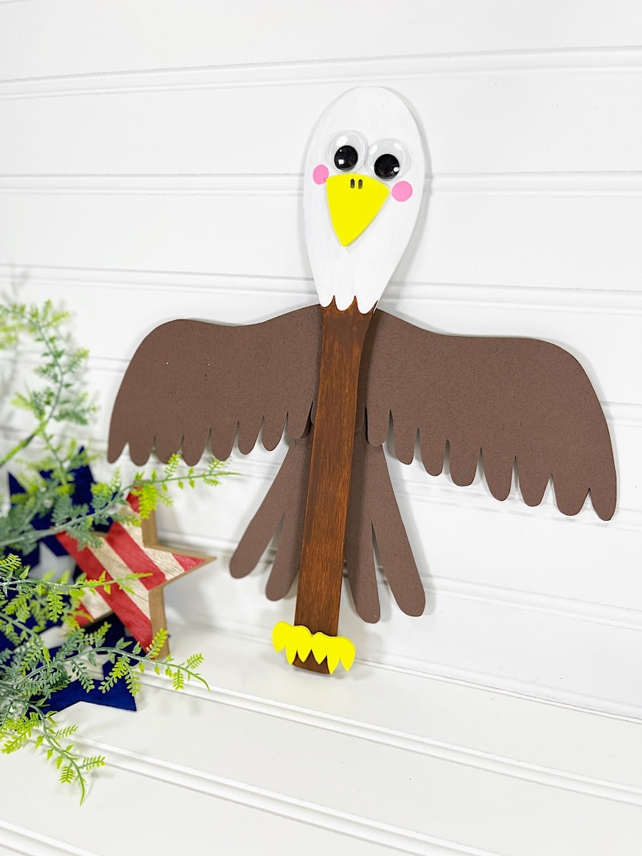 Wooden Spoon Bald Eagle Craft Against White Wall with red stripped star