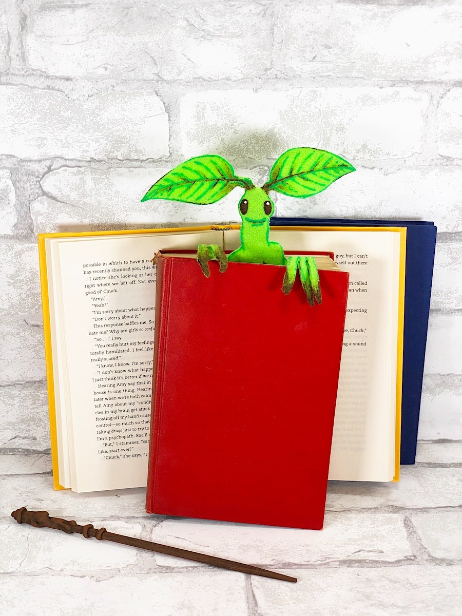 Bowtruckle Craft In Red Book With Wand on white background