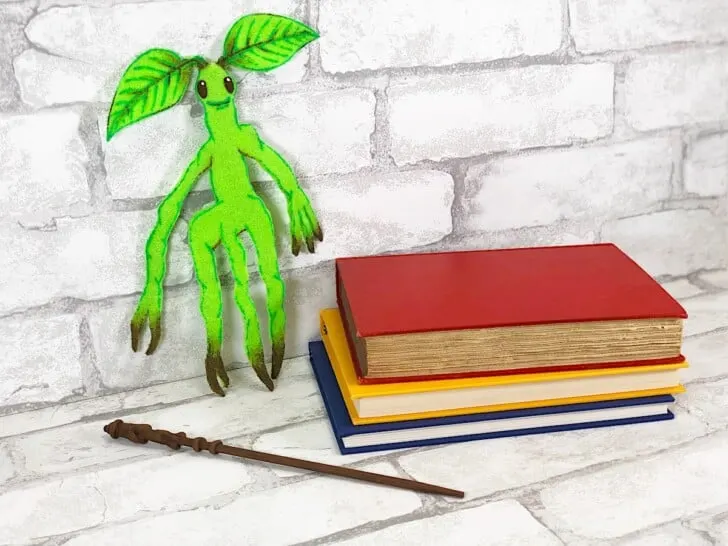 Bowtruckle Craft With Books and Wand against white brick wall