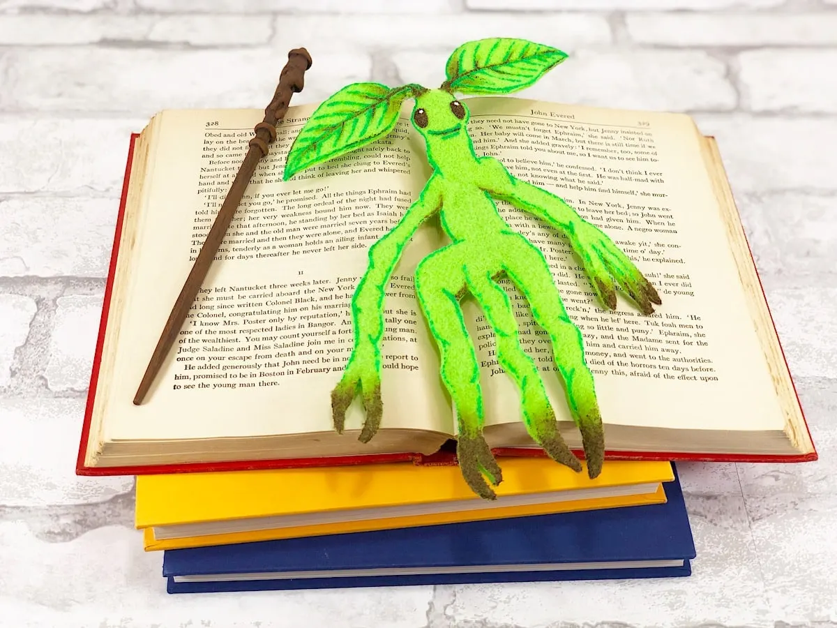Bowtruckle Craft With Wand in Open Book on white brick background