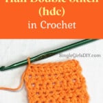 orange yarn and a green crochet hook working a half double stitch against a white background