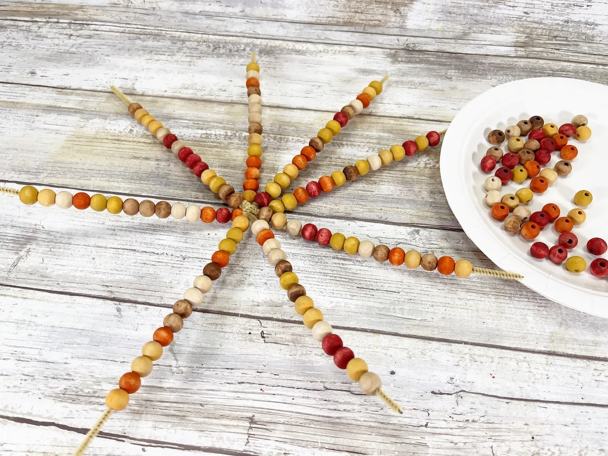 Bead Corn Step 7 on a wood background