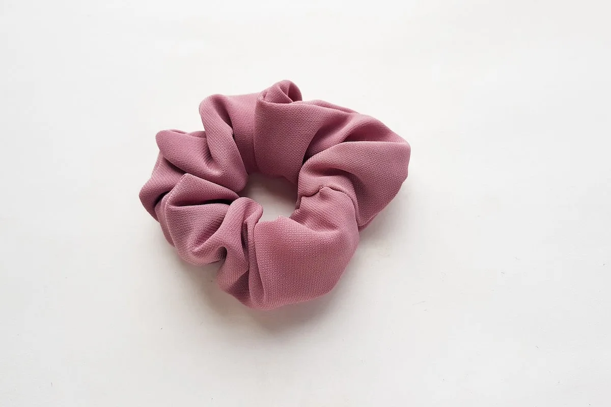 Bow Scrunchie Step 7 A pink scrunchie on a white surface.