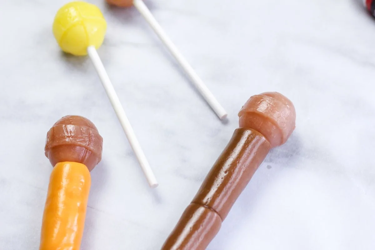 tootsie roll candies wrapped around the stick of a lollipop
