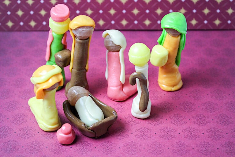 A group of figurines on a pink background.