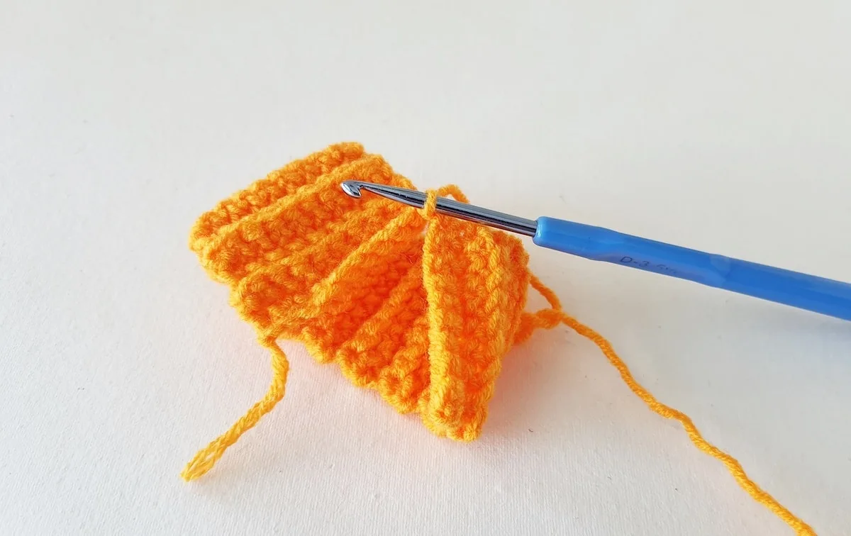Crochet Pumpkin Step 10 against a white background