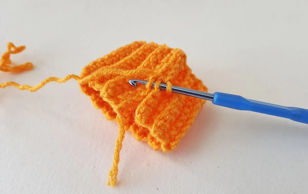 Crochet Pumpkin Step 11 against a white background