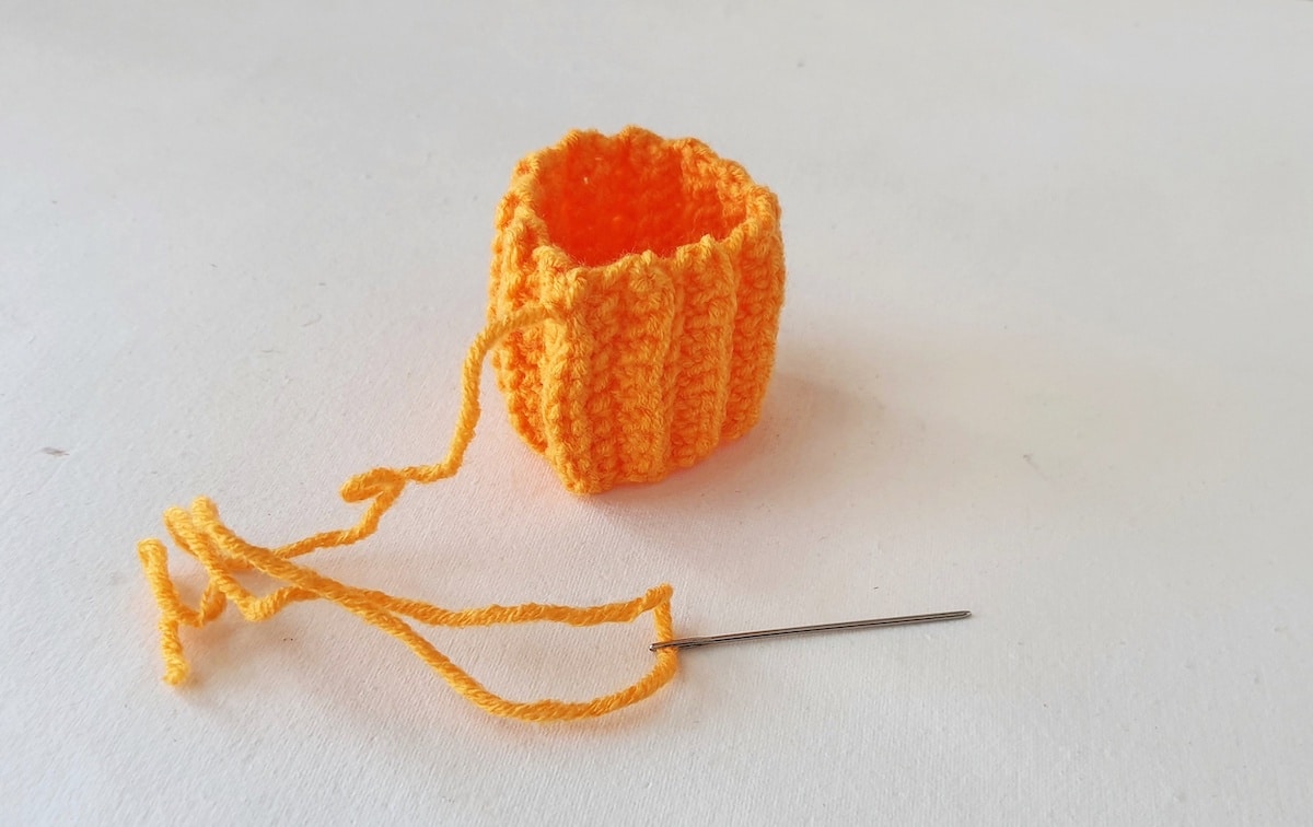 Crochet Pumpkin Step 12 against a white background