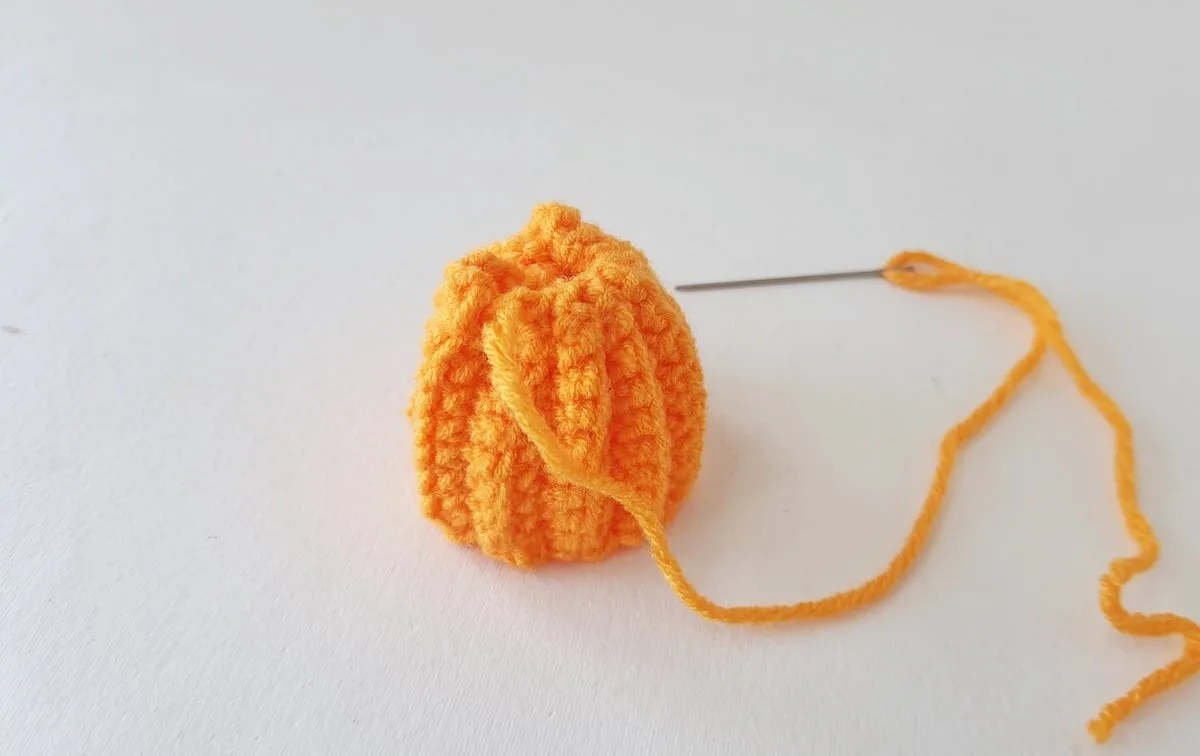 Crochet Pumpkin Step 15 against a white background